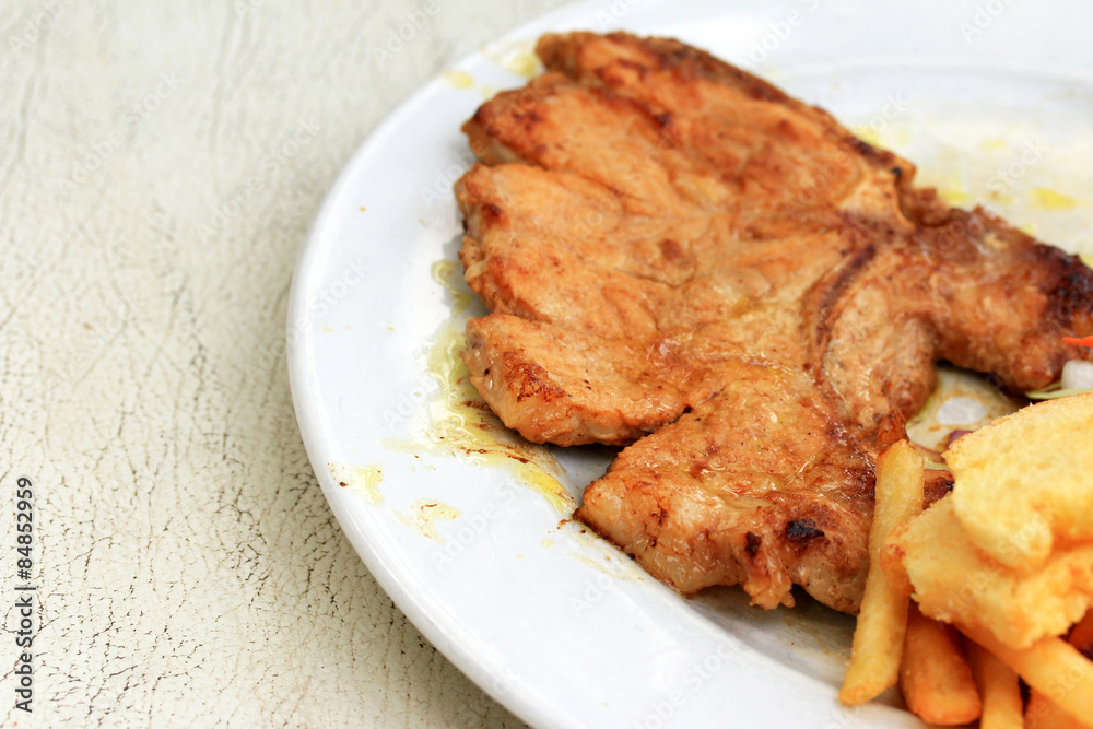Pork chop, french fries with salad Pork chop, french fries with salad