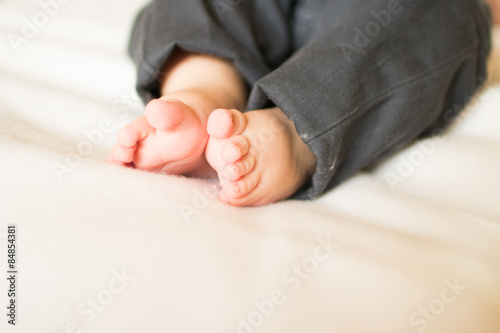 Cute little baby feet on white blanket   © stopabox