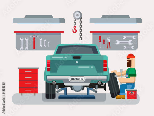 Mechanic Repairs Car in the Garage