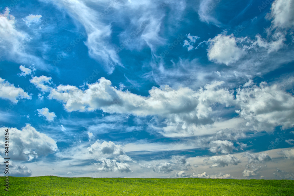 Funny clouds over green meadow Funny clouds over green meadow
