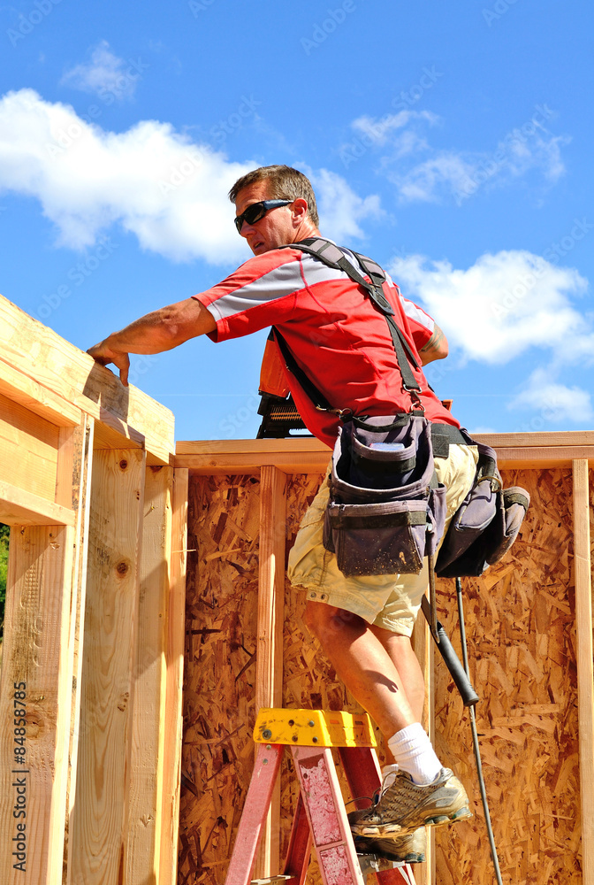 Building contractor worker with a air nail gun  