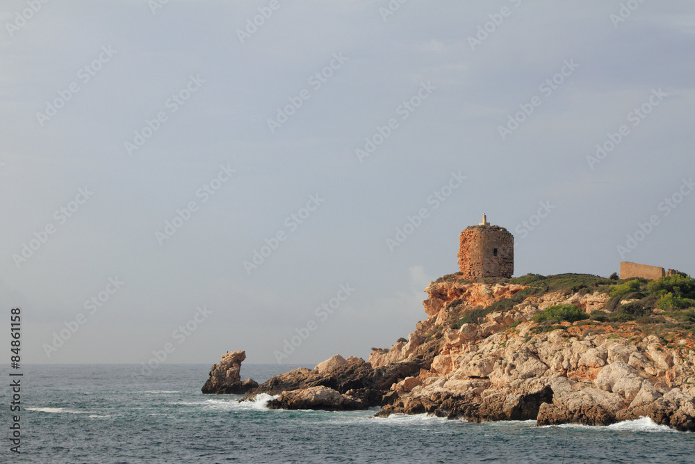 Ancient watchtower on rocky sea coast. Illetes, Palma-de-Majorca, Spain
