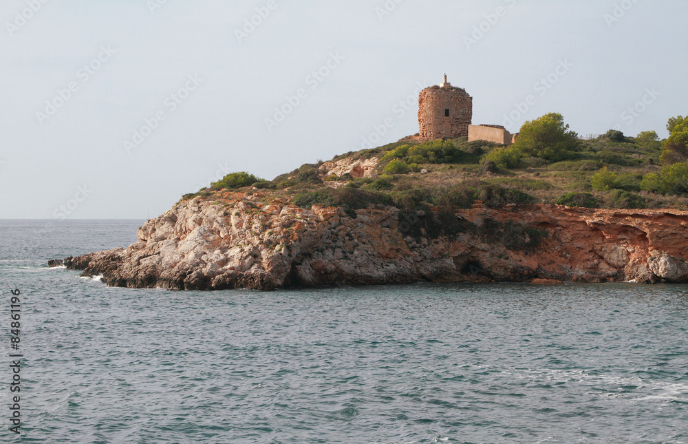 Rocky sea coast and ancient watchtower. Illetes, Palma-de-Majorca, Spain