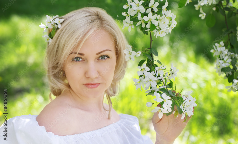 A young woman with a branch of Apple blossoms A young woman with a branch of Apple blossoms