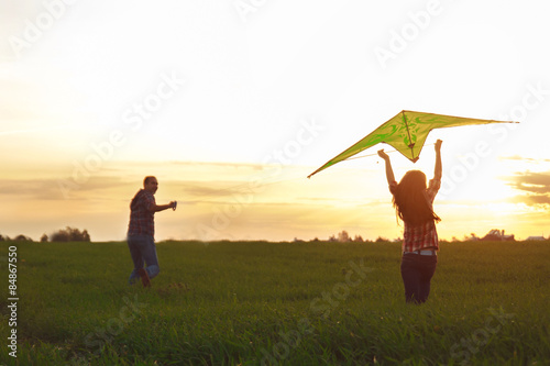 A man with a girl launches a kite 
