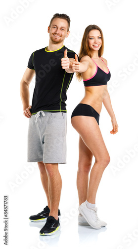 Athletic man and woman after fitness exercise with thumbs up on