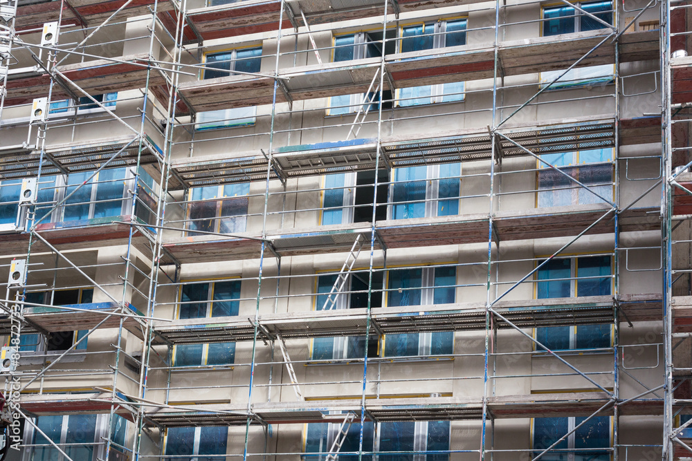new building construction site with scaffolding new building construction site with scaffolding