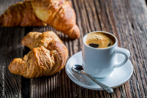 Delicious coffee and fresh croissant for breakfast