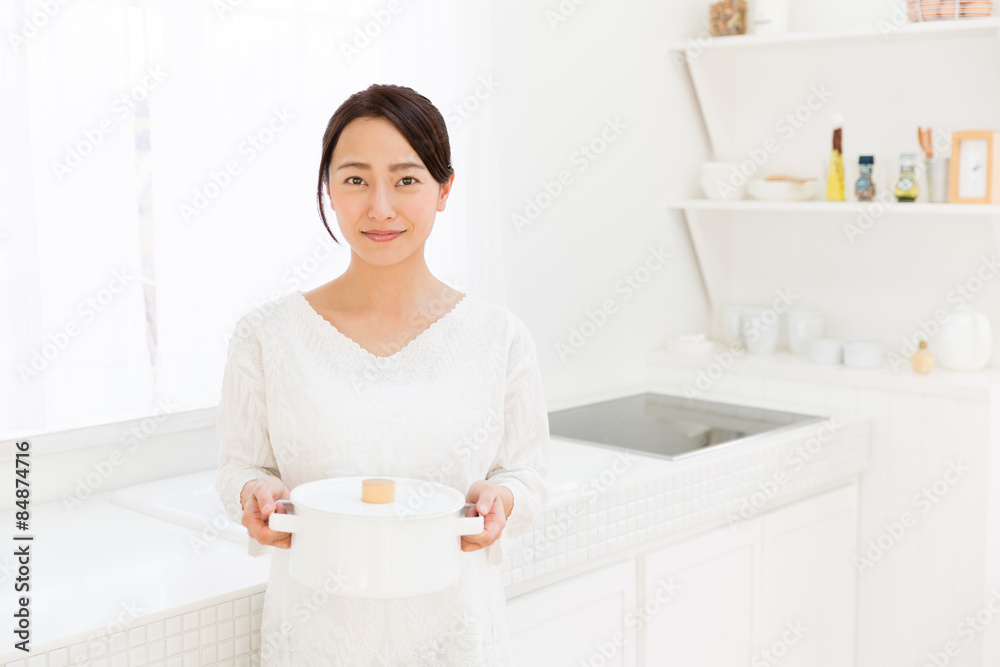 young asian woman in the kitchen young asian woman in the kitchen