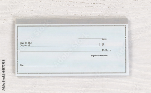 Blank checkbook on white desktop
