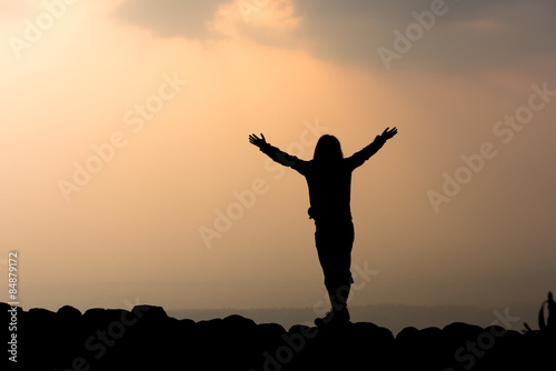 Silhouette of woman and sunset background