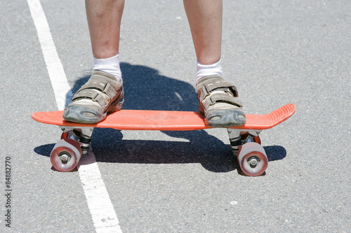 Children's legs on a skateboard