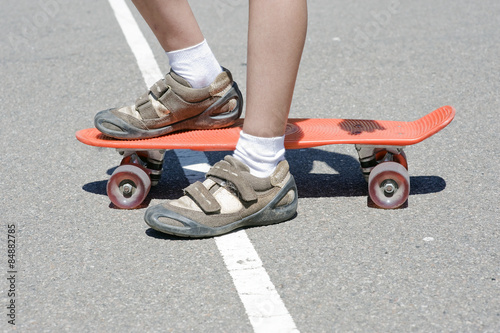 Children's legs on a skateboard