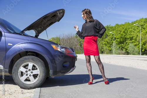 Photography Female driver inspects her car engine