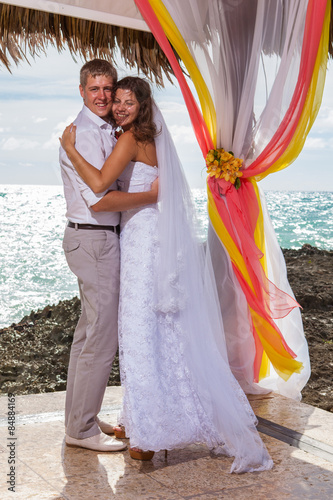 Young loving couple wedding in gazebo