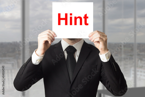 Billede på lærred businessman hiding face behind sign hint