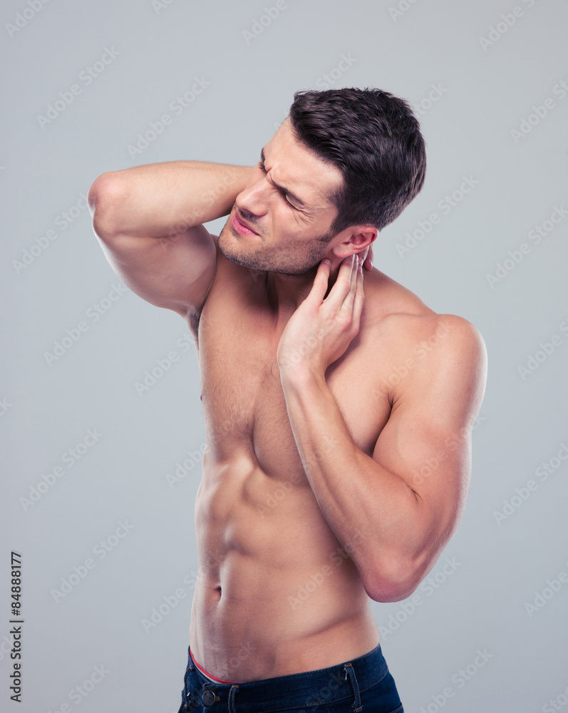 Portrait of a muscular man with neck pain Portrait of a muscular man with neck pain