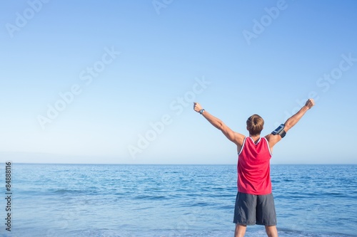 Handsome man raising arms