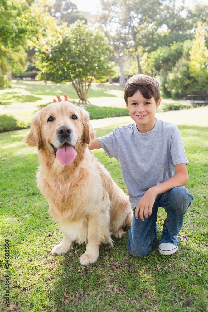 Little boy with his dog in the park Little boy with his dog in the park