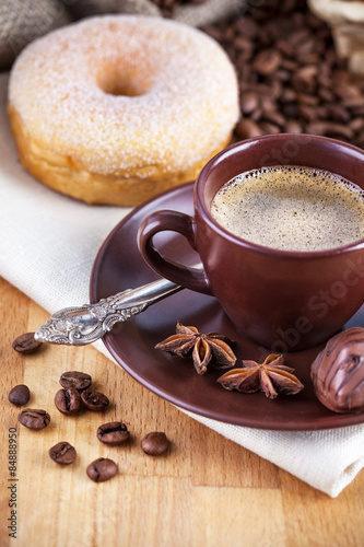 Cup coffee with beans and chocolate candies