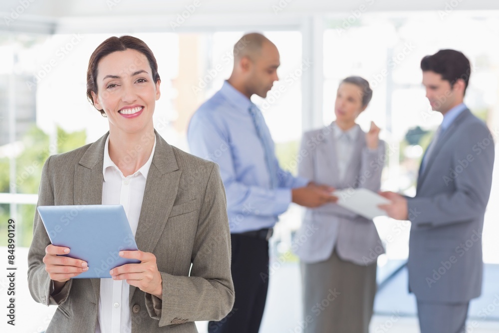 Businesswoman holding tablet and looking at camera Businesswoman holding tablet and looking at camera