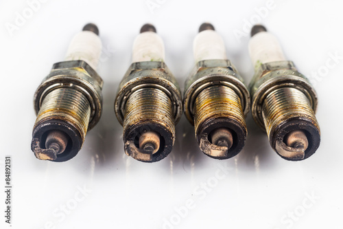 Close up of used spark plugs with focus on electrode with deposits