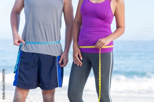 Couple measuring their waist