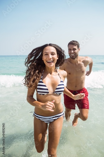 happy couple running out water  © WavebreakmediaMicro