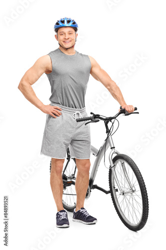 Young biker posing with his bicycle