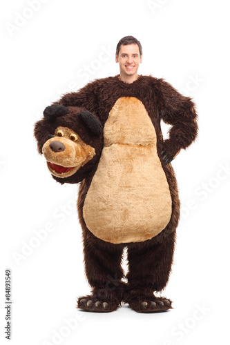 Full length portrait of a young man in bear costume photo