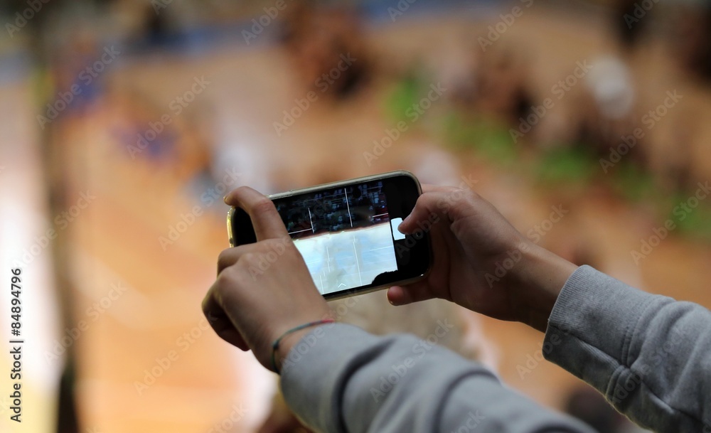 child makes a video with the smartphone during the show child makes a video with the smartphone during the show