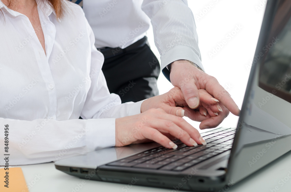 Manager putting his hand on the hand of his secretary Manager putting his hand on the hand of his secretary