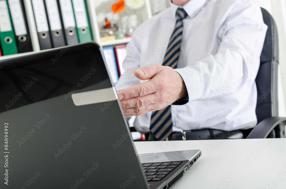 Businessman showing the screen of his laptop