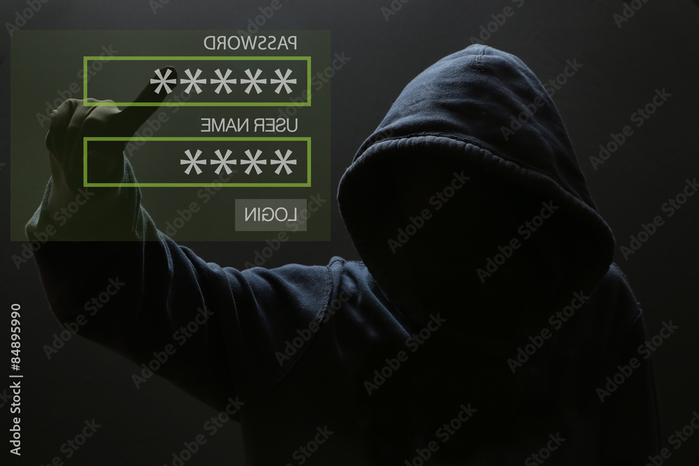 Silhouette of a hacker, Male thief typing password on virtual screen - computer hacker Silhouette of a hacker, Male thief typing password on virtual screen - computer hacker