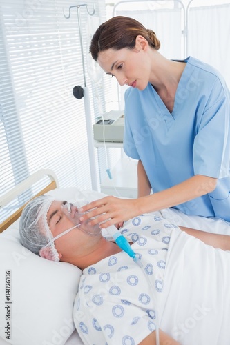 Doctor holding patients oxygen mask