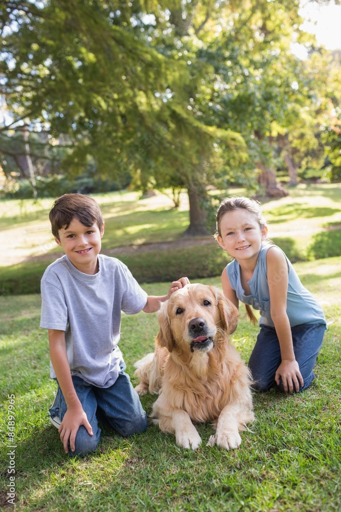 Sibling with their dog in the park Sibling with their dog in the park