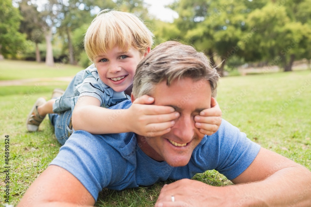 Fototapeta premium Happy father and his son smiling at camera