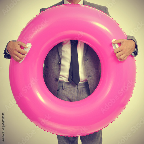 businessman with a pink swim ring, with a retro effect