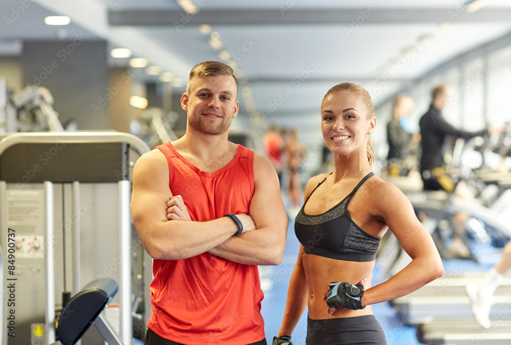 smiling man and woman in gym smiling man and woman in gym