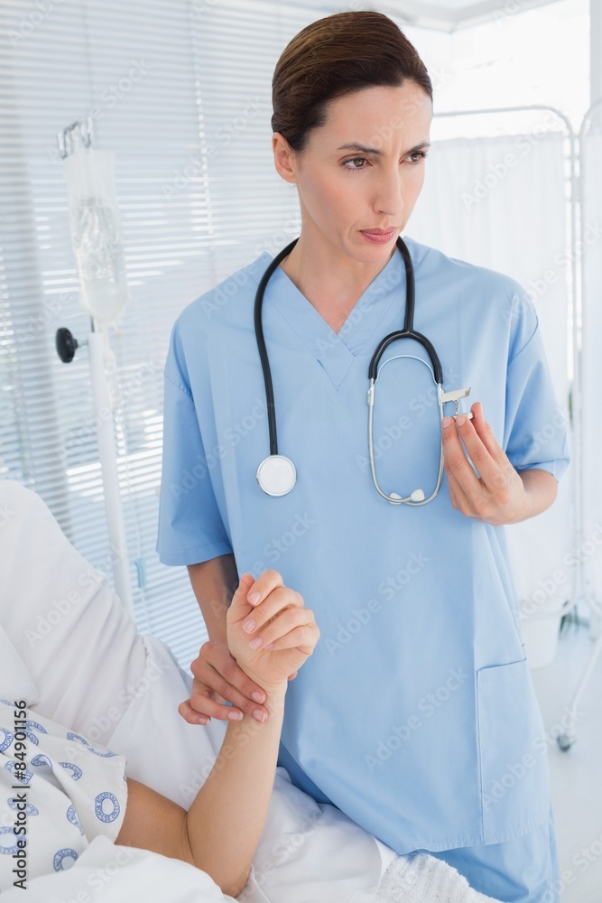 Doctor checking her patients heartbeat Doctor checking her patients heartbeat
