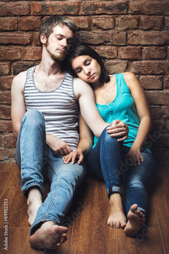 young couple in love sitting on the floor