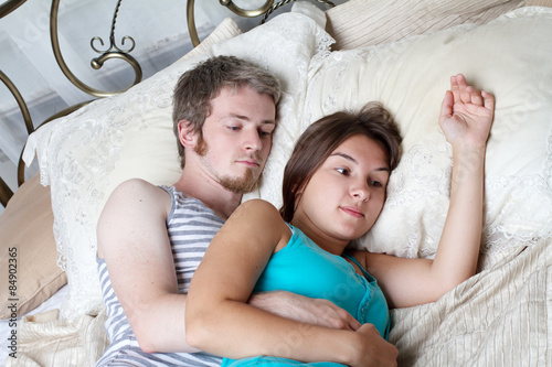 young couple lying in bed