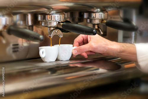 Man working in a coffee house preparing espresso