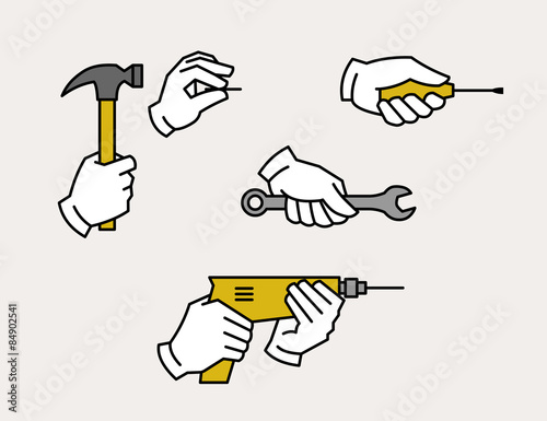 Hand holding drill, spanner, screwdriver, hammer and nail. Hardware tools.