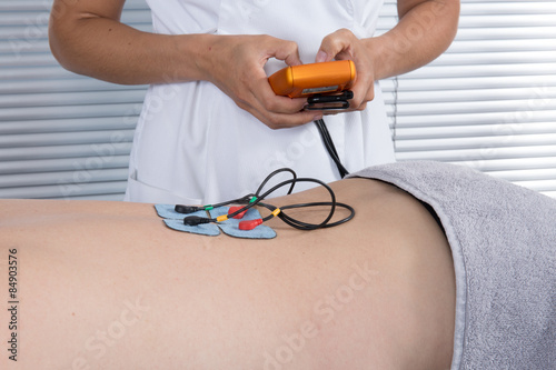 Man with electrostimulator electrodes on his Back