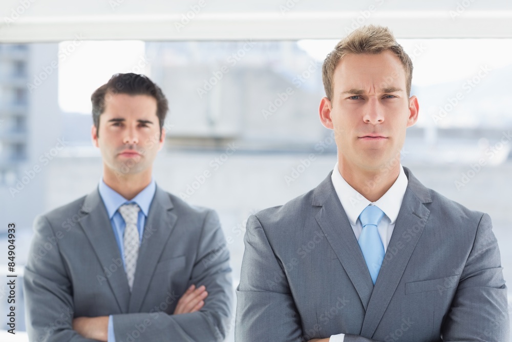 Two businessmen frowning at camera Two businessmen frowning at camera