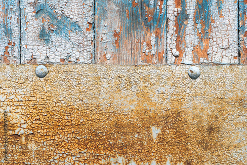door of planks reinforced sheet of rusty metal