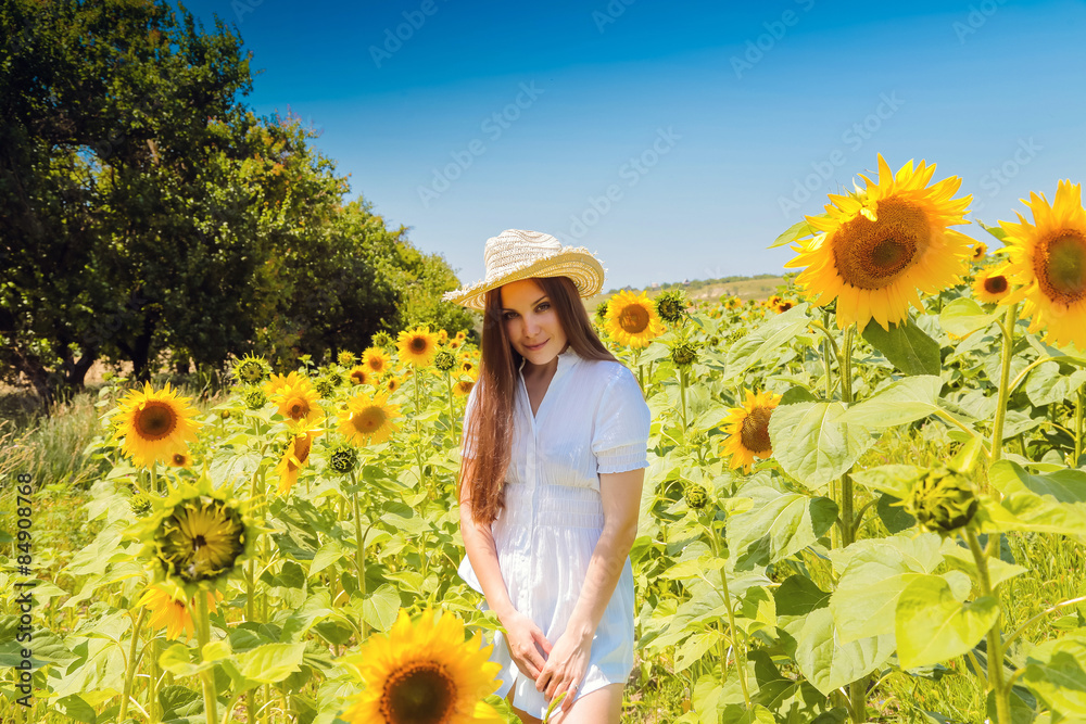 young beautiful woman between sunflowers young beautiful woman between sunflowers
