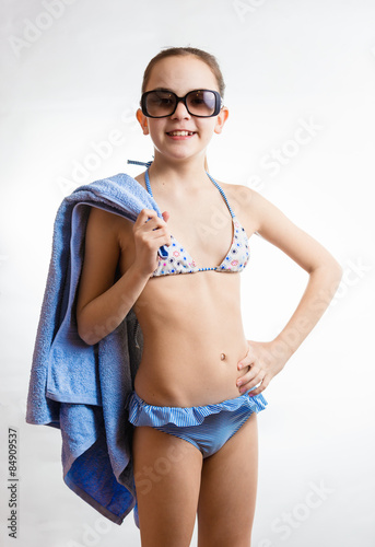 happy smiling girl in sunglasses holding beach towel © Кирилл Рыжов
