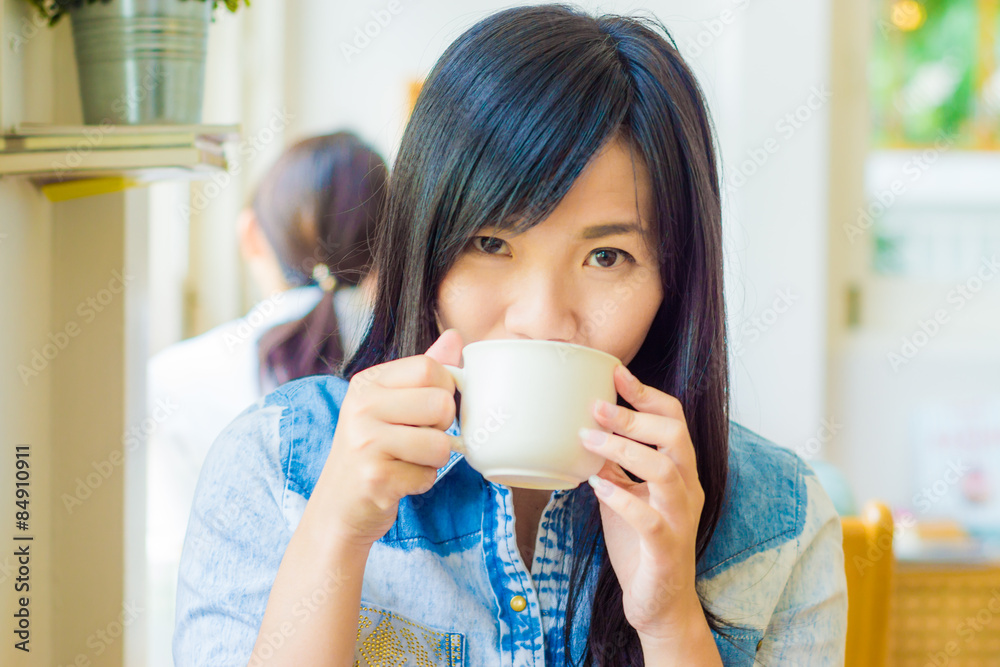 Woman with cup of coffee smiling in cafe Woman with cup of coffee smiling in cafe